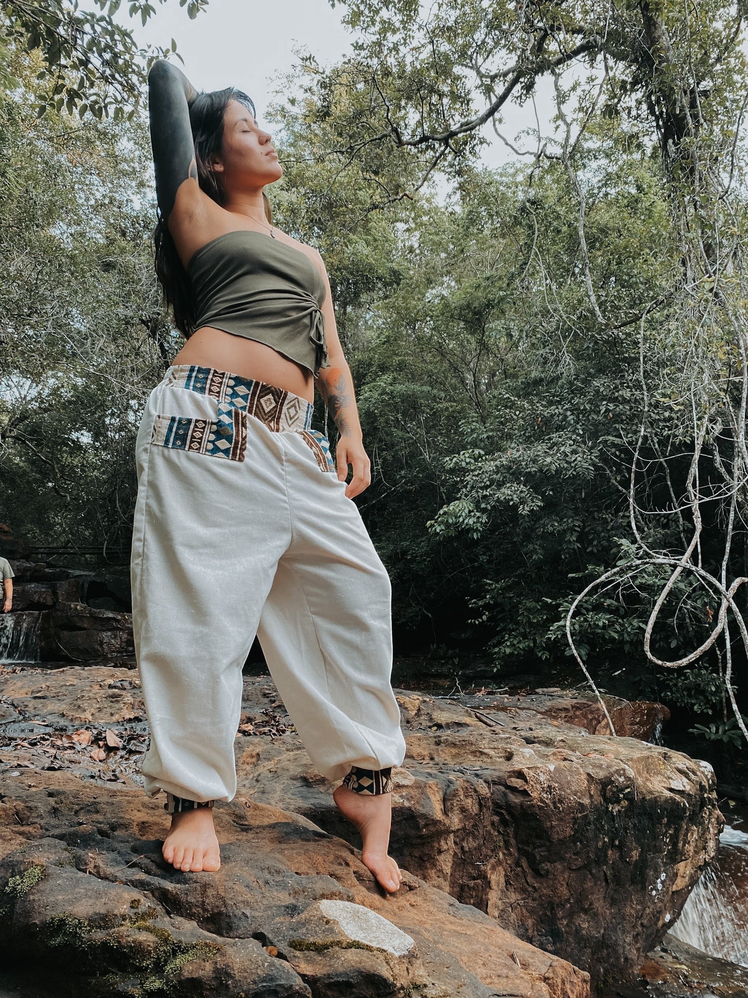 Goa Nomads off-white linen pants with Ganesha print on waistband and ankle cuffs. Loose fit, bohemian style.