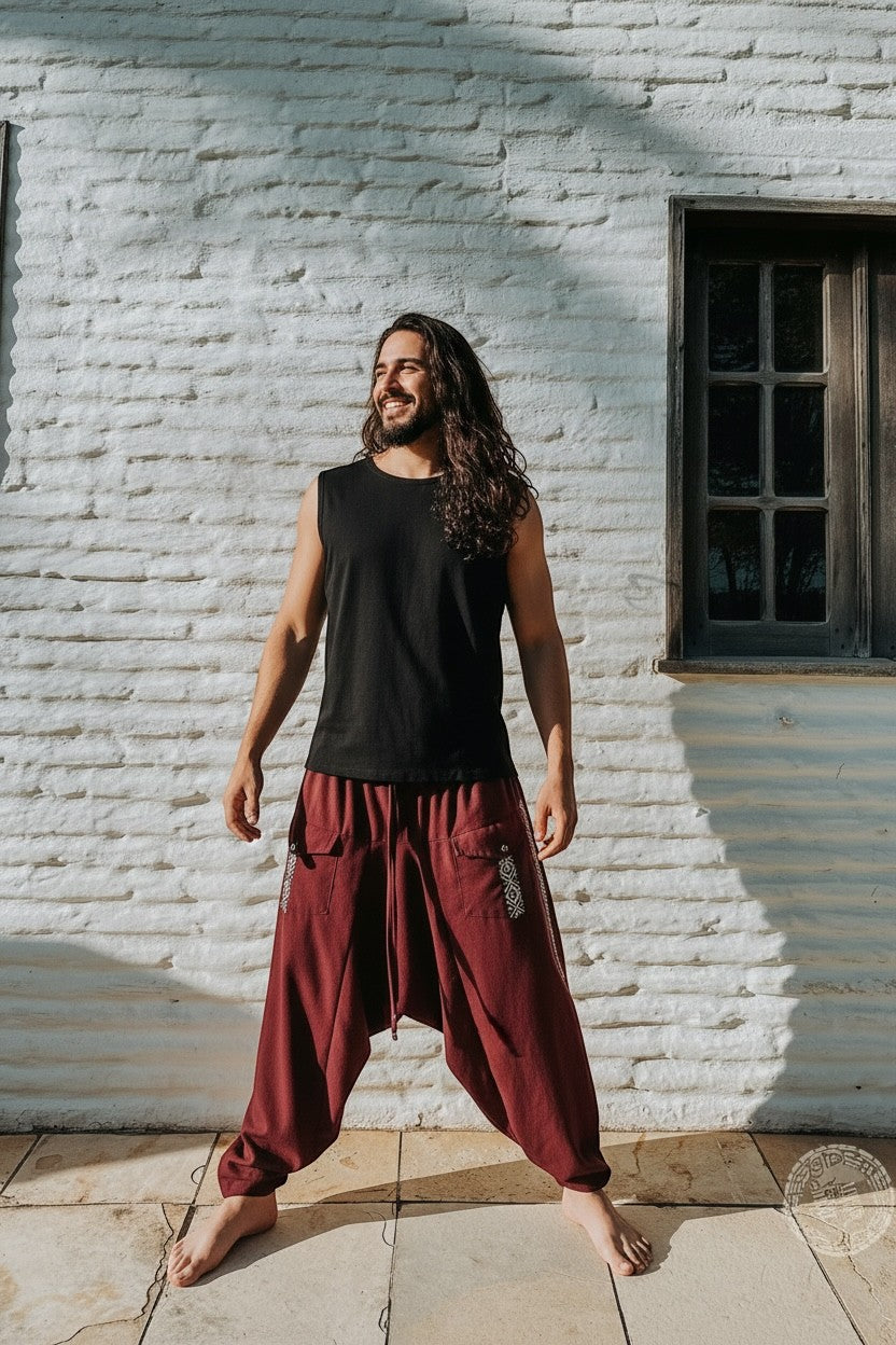 Goa Nomads men's wine-colored linen Aladdin pants with ethnic side tape and asymmetrical pockets.
